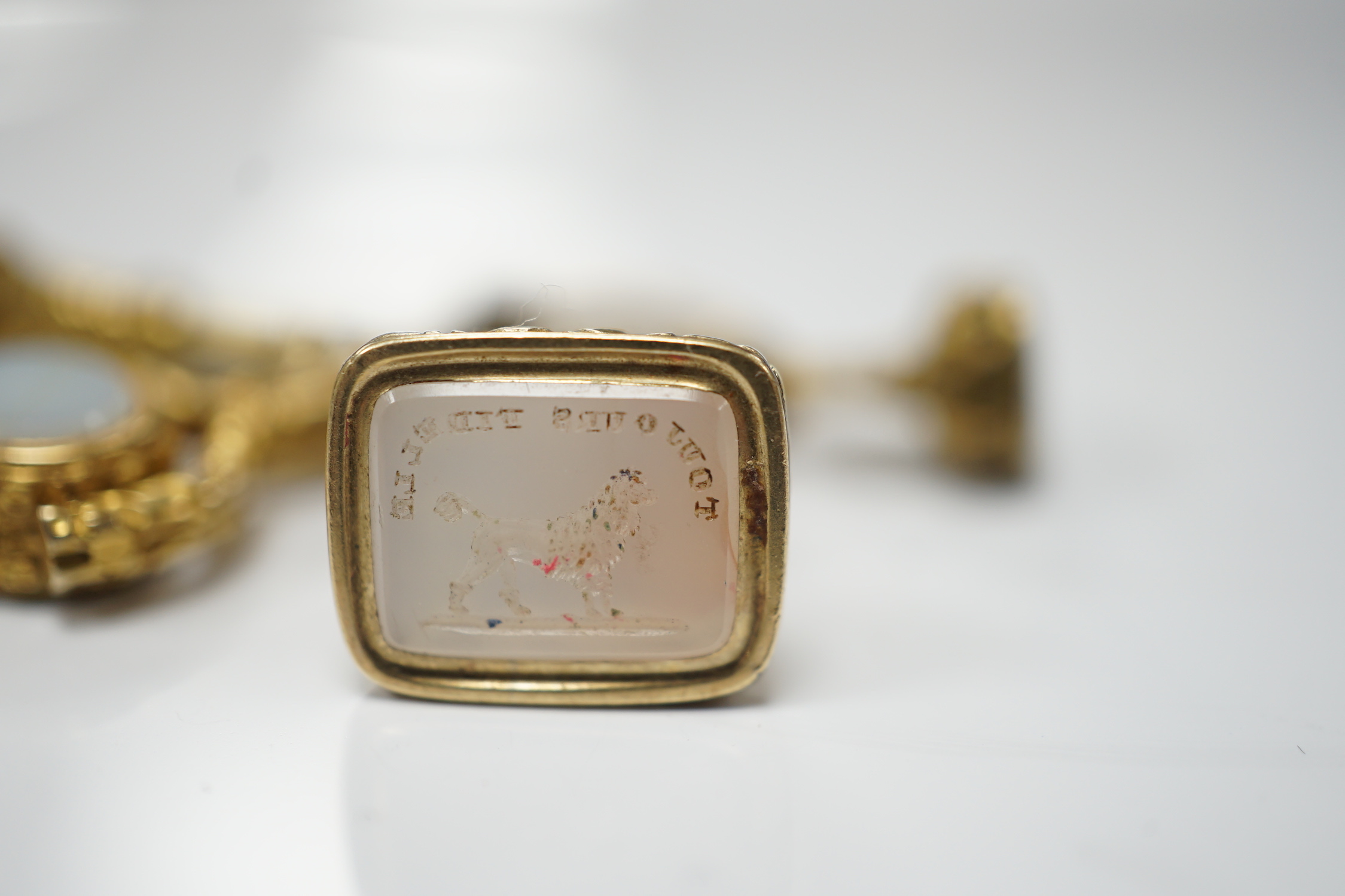 Three assorted 19th century yellow metal overlaid and chalcedony set fob seals and one other item, all mounted on a loop ring, largest approx. 20mm.